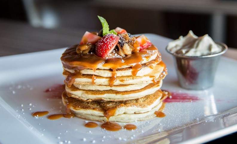 Pancake stack with berries and syrup